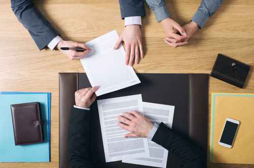 Couple signing marriage documents